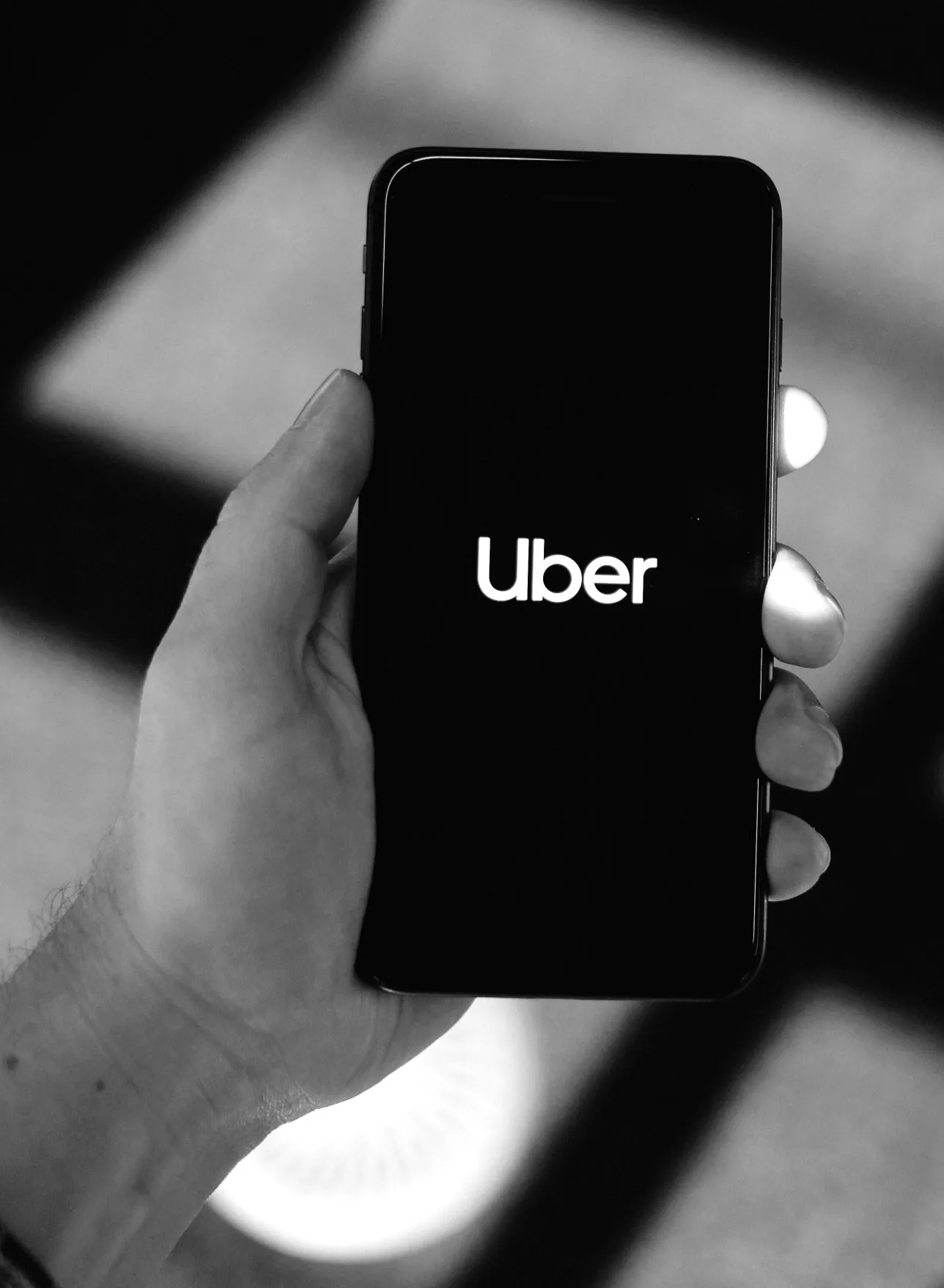 A user loading the Uber app on their phone